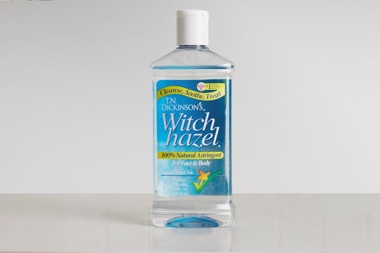 bottle of  T.N. Dickinsoon's brand witch hazel natural astringent face and body cleanser, on a soft white background with copy space