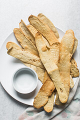 Overhead view of homemade crackers, top view of freshly baked onion cracker biscuits, process of making flatbread onion crackers