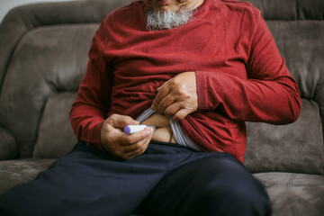 Asian Old Male Makes Injection In Stomach Belly Or Abdomen For Treating Diabetes At Home