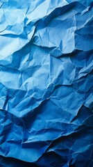 Obraz premium Abstract view of crinkled paper, showcasing a spectrum of blues and shadow play for added depth and texture.