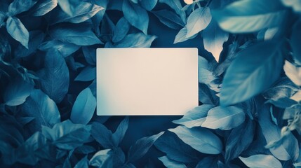 Blank card surrounded by vibrant blue leaves