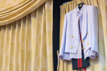 A ceremonial military uniform hangs on a curtain