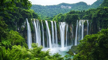 Naklejka premium Lush Jungle Waterfall Tranquil Nature Scene