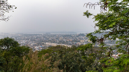 Shot of Guwahati city in Assam from top of Gandhi Mandap with more trees in the foreground 2