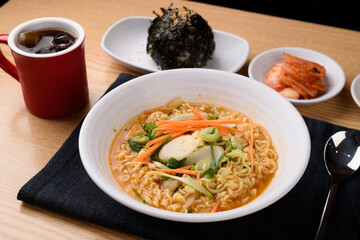 Spicy rice cake ramen in a white bowl