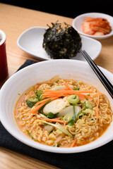 Spicy rice cake ramen in a white bowl