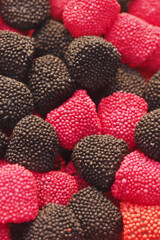 Colorful candy assortment featuring black and red gummy treats