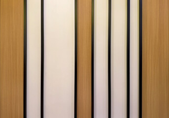 Close up of wall panel design, series of stripes and fluted panel in wood tone material, black strips, and white paint. Seamless background texture.