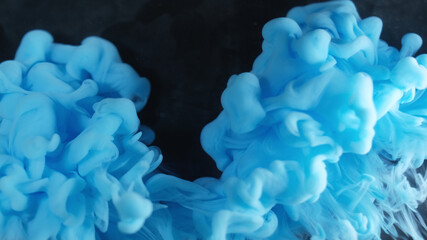 Underwater smoke. Art vapor. Blue mist cloud flow on black background. Color paint fume spread...