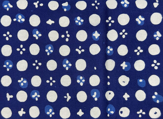 Traditional ethnic fabric in random abstract swirls, geometric, and floral pattern. Ethnic cloth dyed blue, and white color. Seamless background texture.