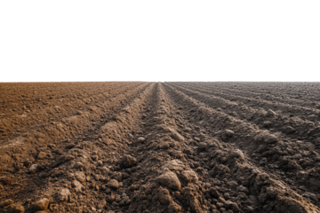 Brown plowed soil with deep furrows stretching into the distance, symbolizing agricultural preparation and earth's natural beauty.