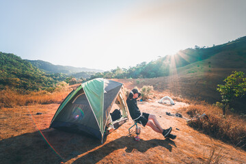 wanderlust and relax in nature with hiker man camping on top of mountain on spring and summer season