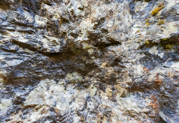 the walls of a stone gorge in a mountainous area, the structure of a geological section