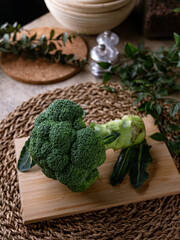 Organic Raw Fresh Green Broccoli on wooden board. Vegetables for diet and healthy eating.