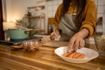 Woman preparing ingredients on a wooden kitchen counter for delicious meal