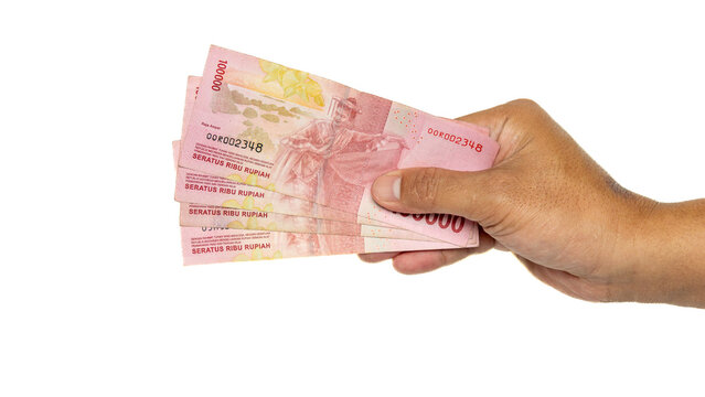 A Hand is holding Indonesian currency with white background