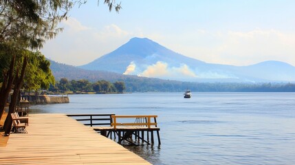 Serene lake view with wooden pier, mountain backdrop, and distant boat