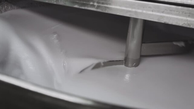 Industrial mixer in cosmetic factory mixing ingredients for cosmetics. Cosmetic factory. Production of skin care cream. Cosmetics production. Tank for preparing cosmetics at a factory. 