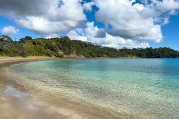 Northland, New Zealand scenery. Tauwhara Bay near Whananaki. Secluded beach only accessible by boat or via private land. Calm clear turquoise water.