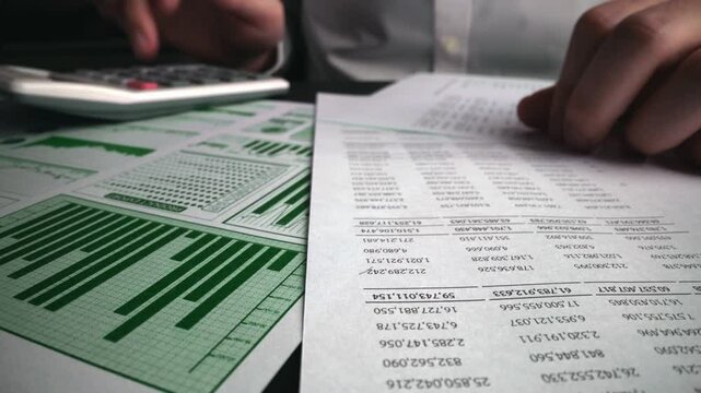 Accountant analyzing business marketing data on paper dashboard at office table. Corporate finance and money accounting concept.