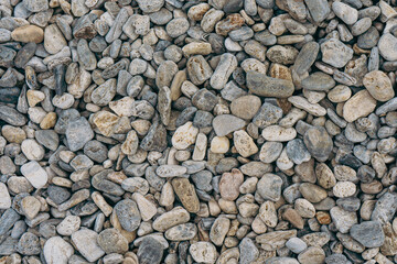 Small stones background, stone seashore texture