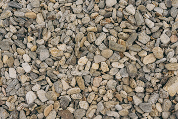 Small stones background, stone seashore texture