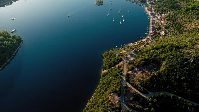 Slow drone reveal shot of Vathy village in Ithaca island during sunrise, Ionian sea, Greece