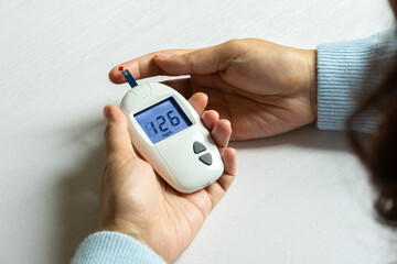hand of people check diabetes and high blood glucose monitor with digital pressure gauge....