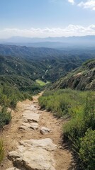 Obraz premium Scenic Hike Down Rocky Trail with Mountain View and Blue Sky