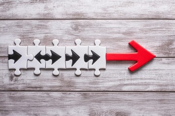 Red arrow leads interconnected puzzle pieces.