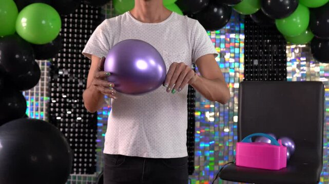 Inflating balloons with electric inflator in party room for decoration