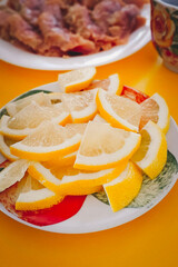 Sliced lemon on a plate. Close-up, set table.