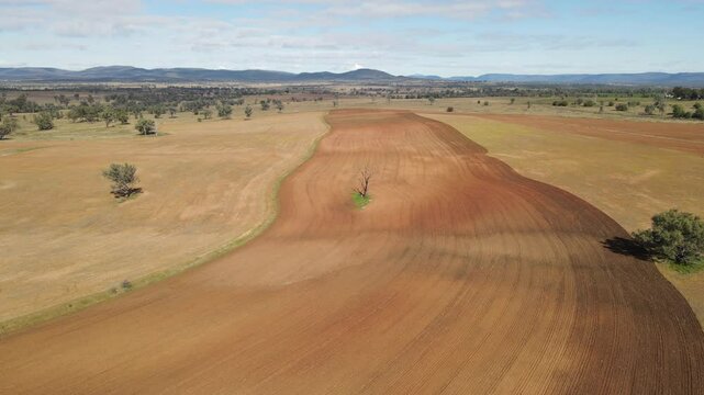 Aerial Drone Over Vast Farmland Revealing Barren Dusty Terrain