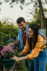Couple taking care of flowers in the garden