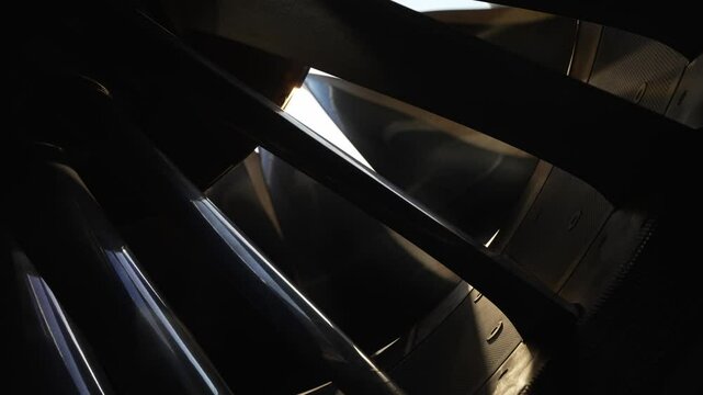 GEnx turbine engine fan blades spinning as sun shines between the fan blades