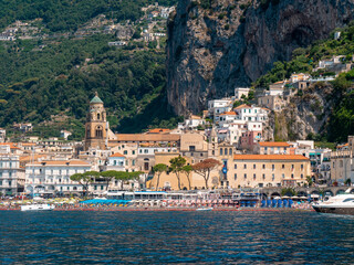Historic Amalfi Town with Cathedral Bell Tower and Crowded Beach during Summer Season, Amalfi Coast, Italy