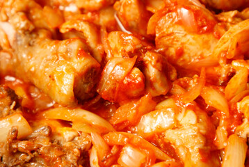 A plate of food with meat and onions