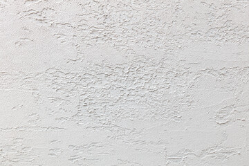 A white wall with a textured surface