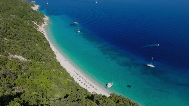 Slow panning drone shot of Gidaki beach with turquoise waters at Ithaca island, Greece