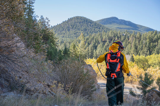 Wildland Firefighter uses backpack pump