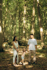 Fototapeta premium Happy Family Enjoying an Outdoor Stroll Together in a Scenic Forest Setting