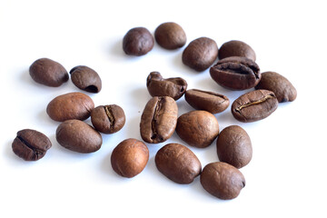 Whole coffee beans lie on a white background. Top view.