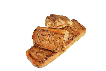 Puff pastry buns with filling lie on a white background.