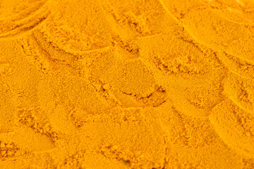 Ground aromatic spice turmeric shot at close range. Textured pattern. © Михаил Жигалин