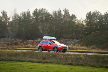 Touring car with roof cargo box countryside