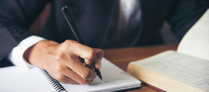 Planner plan Schedule Calendar and reminder agenda, work online at home. Man hand planning daily appointment and write business trip in diary book at office desk. 2025 Calendar reminder event concept.