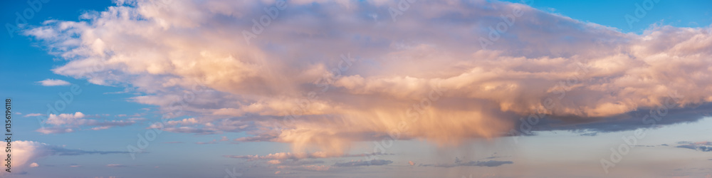 Wall mural panoramic background of beautiful evening sky with rain shower and clouds at sunset