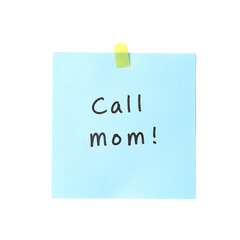 Reminder to call mom on a light blue sticky note vividly standing out on a clean white backdrop