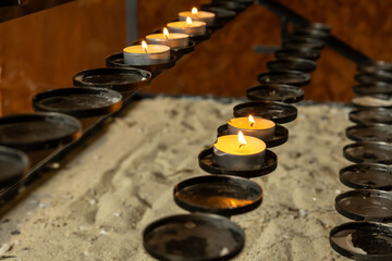 Burning votive candles in a church setting