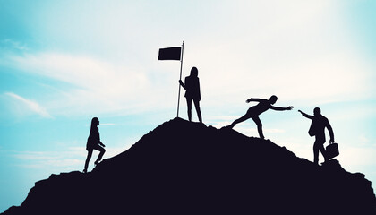 Teamwork and leadership concept with silhouettes of businesspeople helping each other climb a...